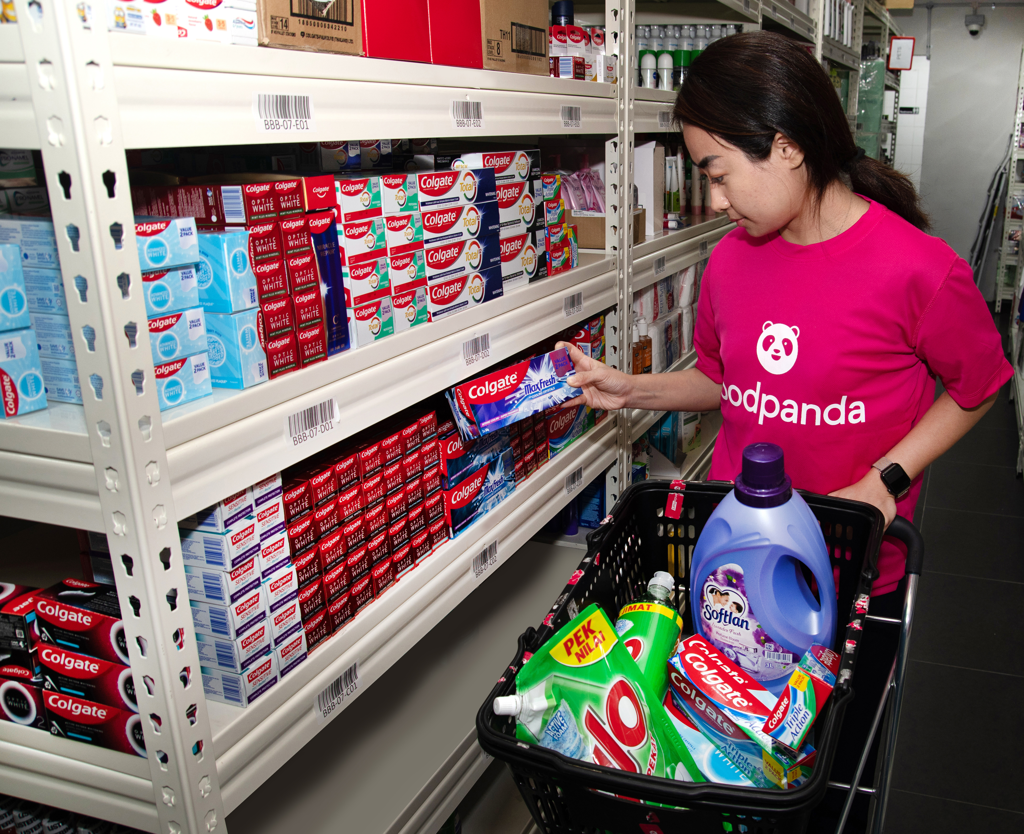 foodpanda staff at pandamart selecting items ordered by customers for delivery. Image attributable to foodpanda