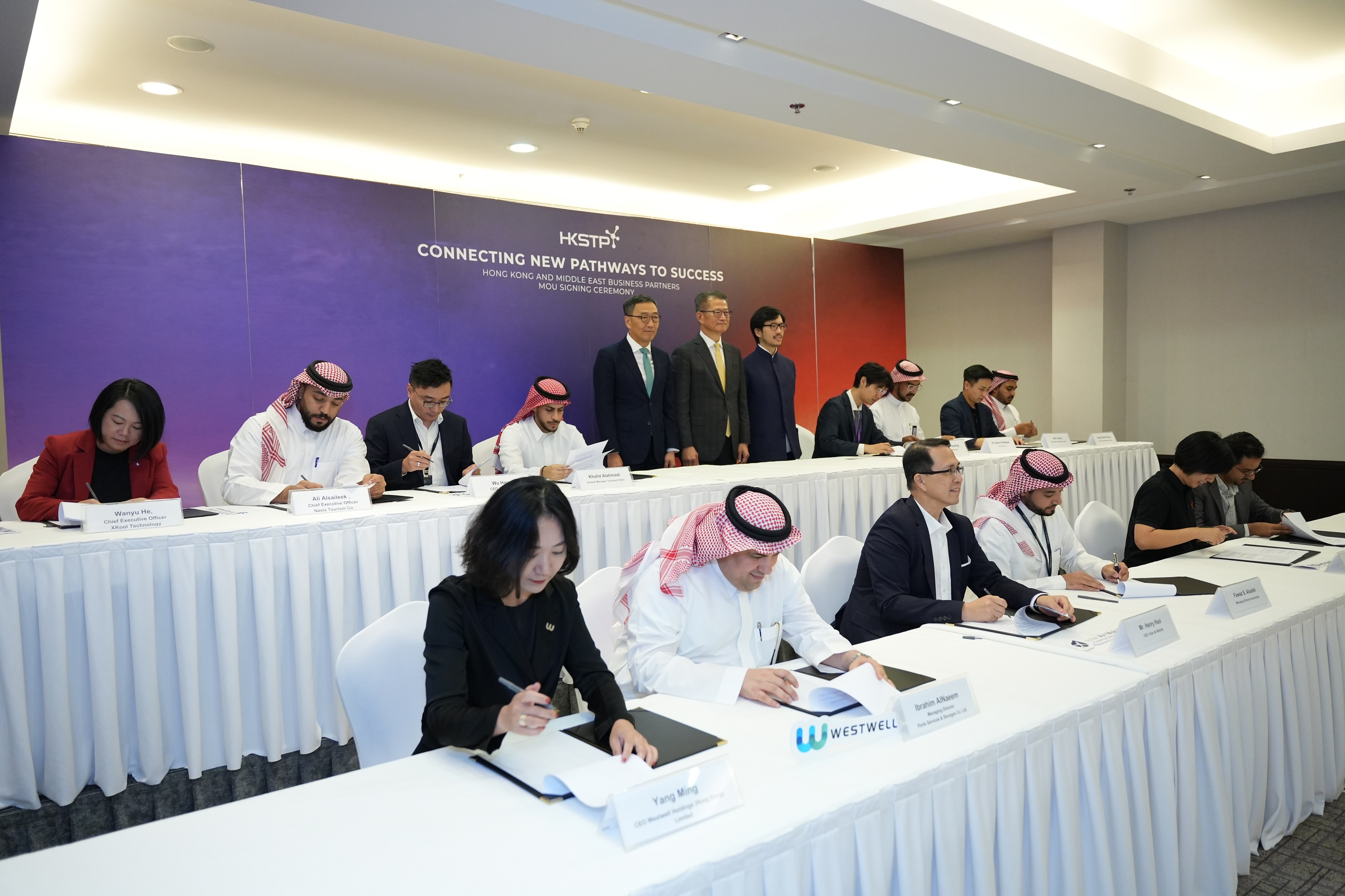 Seven HKSTP Park companies signed MoUs with Middle Eastern organisations under the witness of the HKSAR Financial Secretary Paul Chan (middle of back row), Albert Wong, CEO of HKSTP (left of back row) and Nicholas Ho, HKSAR Commissioner for Belt & Road (right of back row)