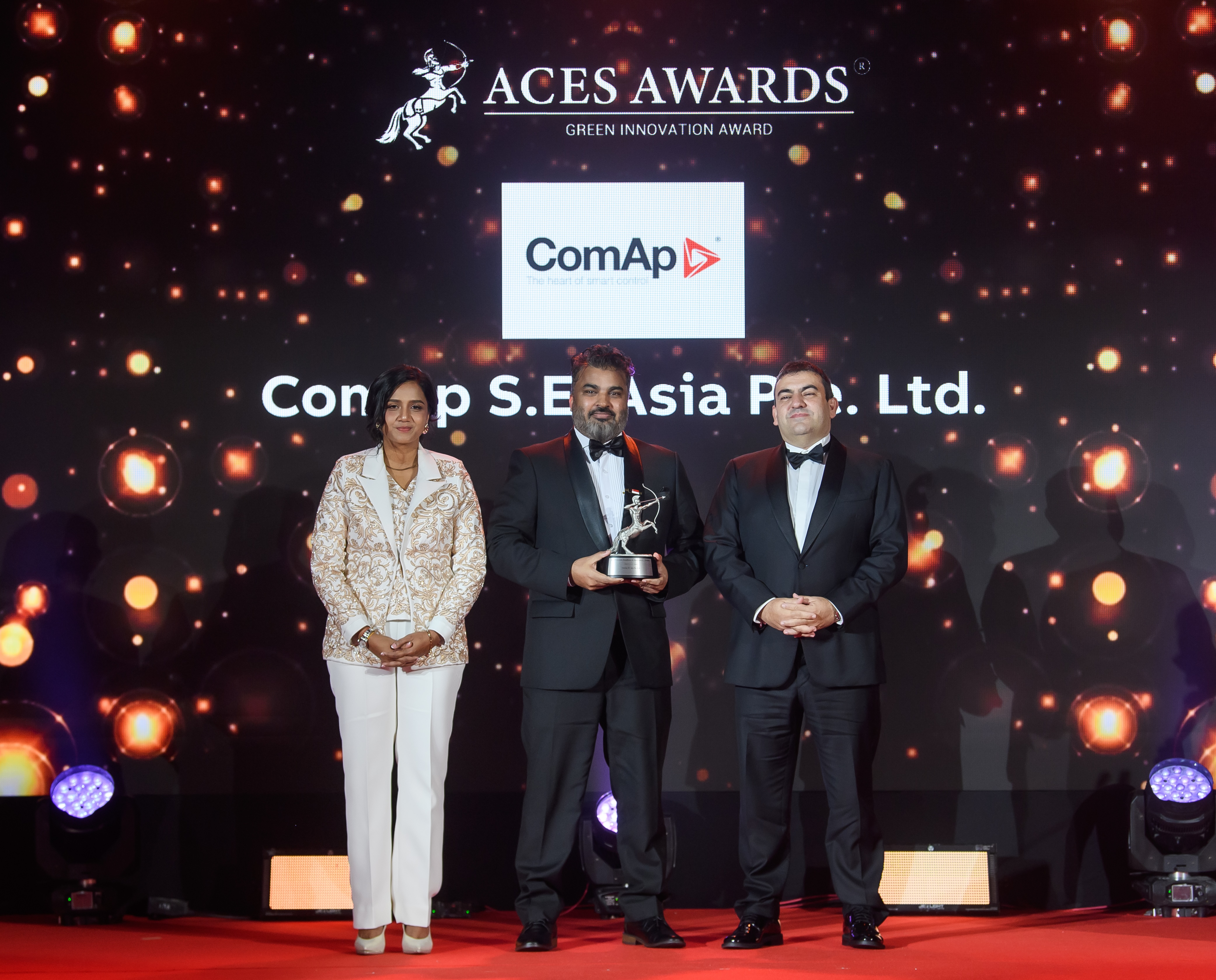 ComAp S.E. Asia Pte. Ltd. Managing Director, Bhuneshwar Prasad (centre), proudly accepts the prestigious ACES Awards trophy on stage from Dr. Shanggari Balakrishnan, President of the ACES Awards (left), and Mr. Luis Bueno Nieto, Advisor to the ACES Council (right).